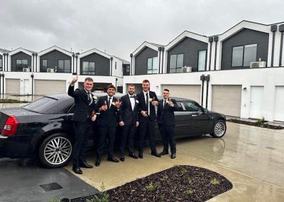 2007 Black Chrysler Limo - Formal Bestmen Groom Wedding in front of car